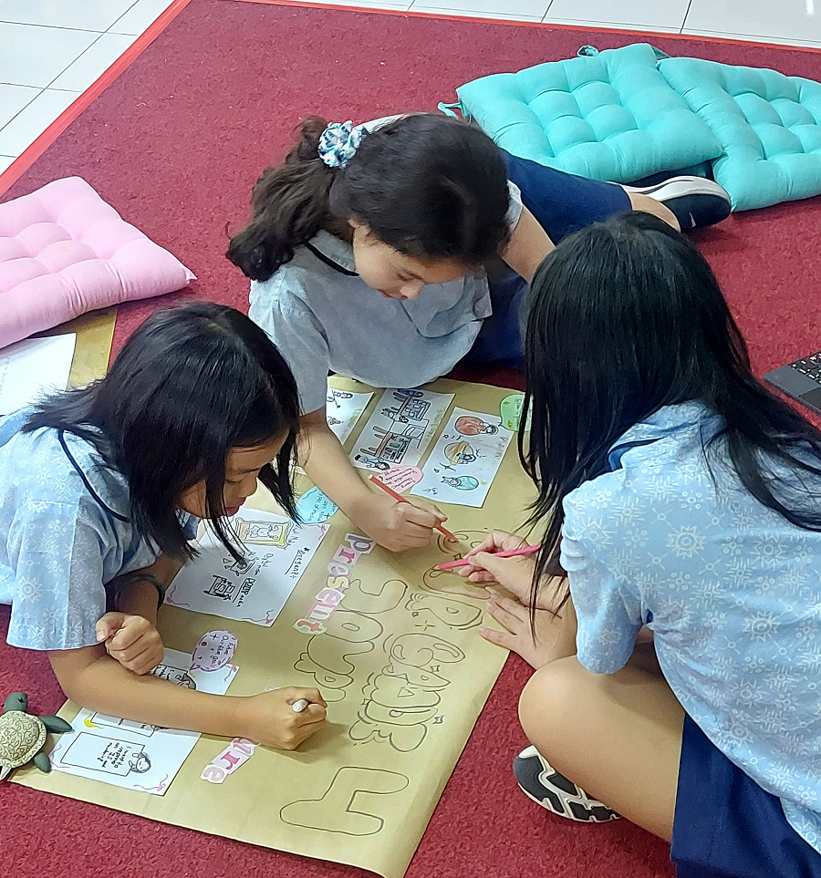 Elo, Dania and Rene working on their poster_ 1.png